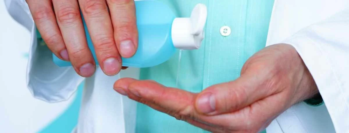 man-using-hand-synthesizer-to-disinfect-his-hands-1200×460